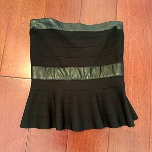 Bebe black knit strapless top with peplum. Leather trim. Back zipper. Size XS.